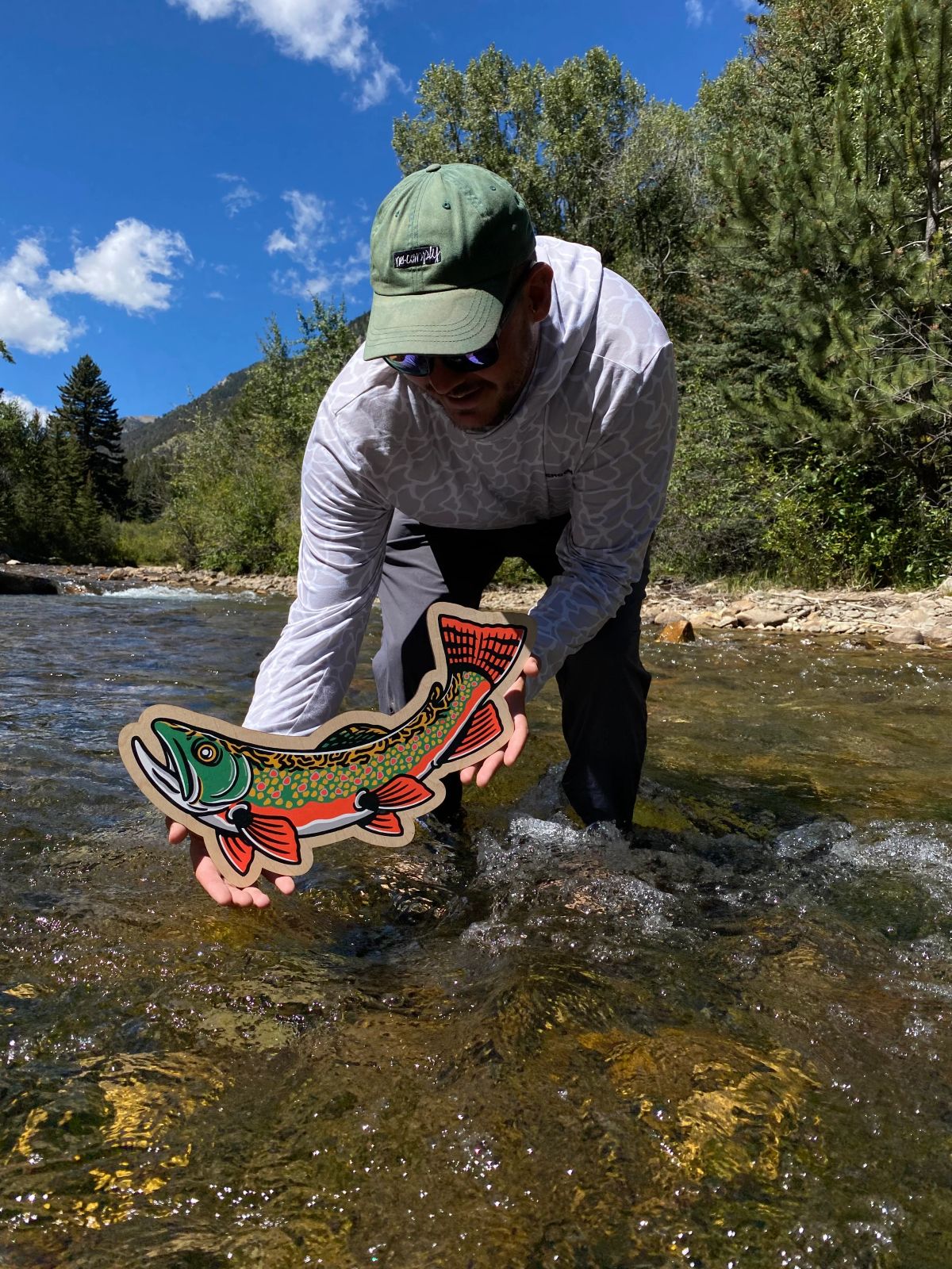 fish art in river being held as if it were a fish that was caught