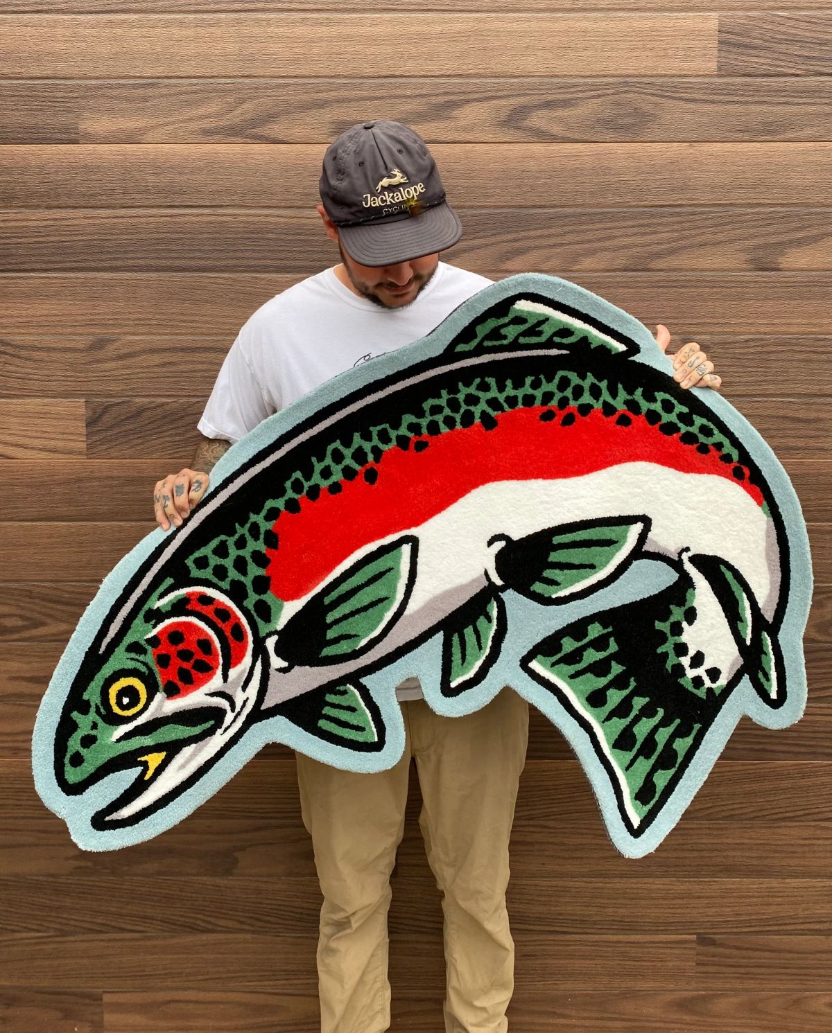 bass fish rug held by the artist